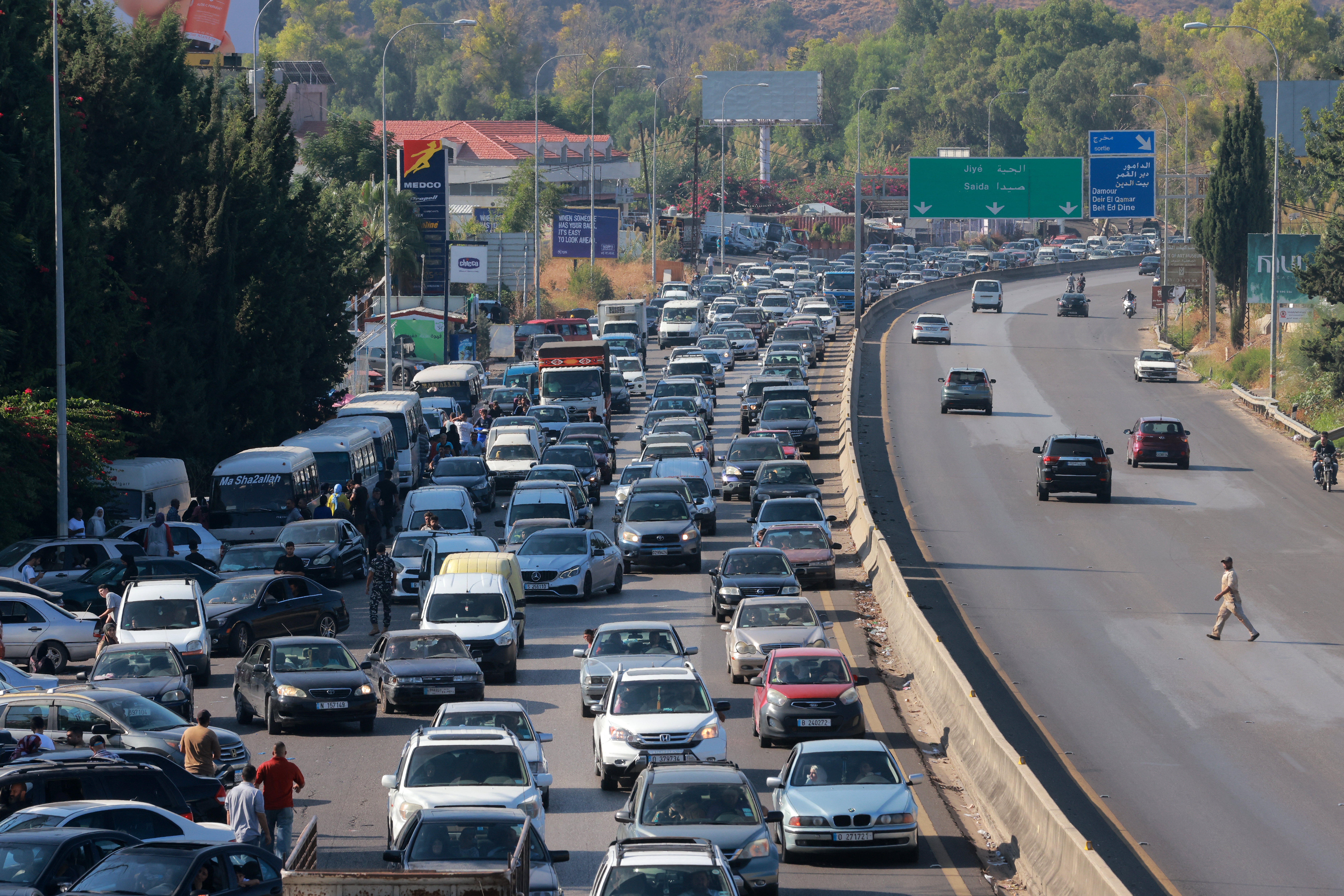 Vehicles wait in traffic in the town </div>
<p><a href=